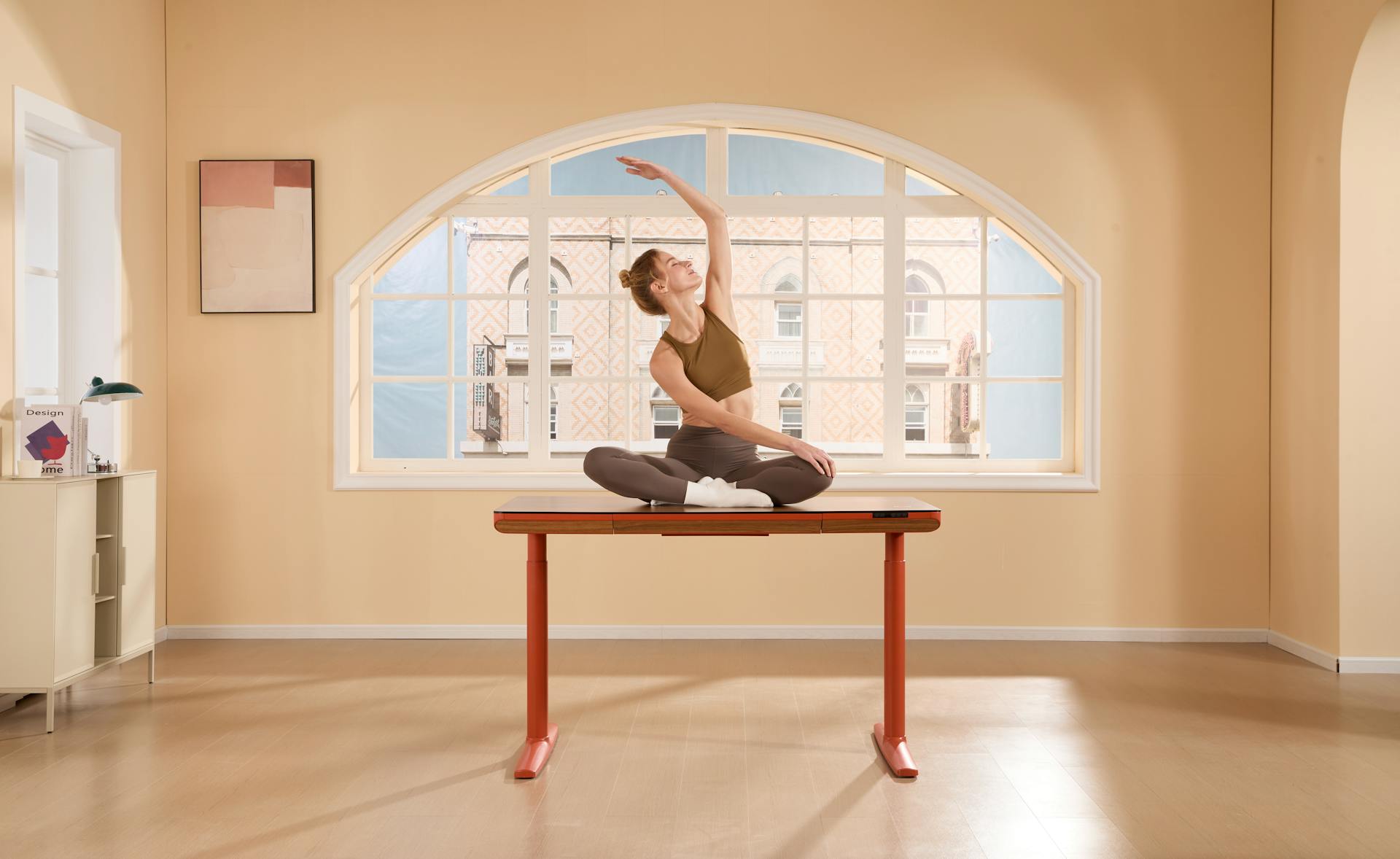 alt=Woman doing seated cat-cow stretch at office desk)